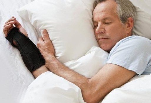 man sleeping with a wrist brace