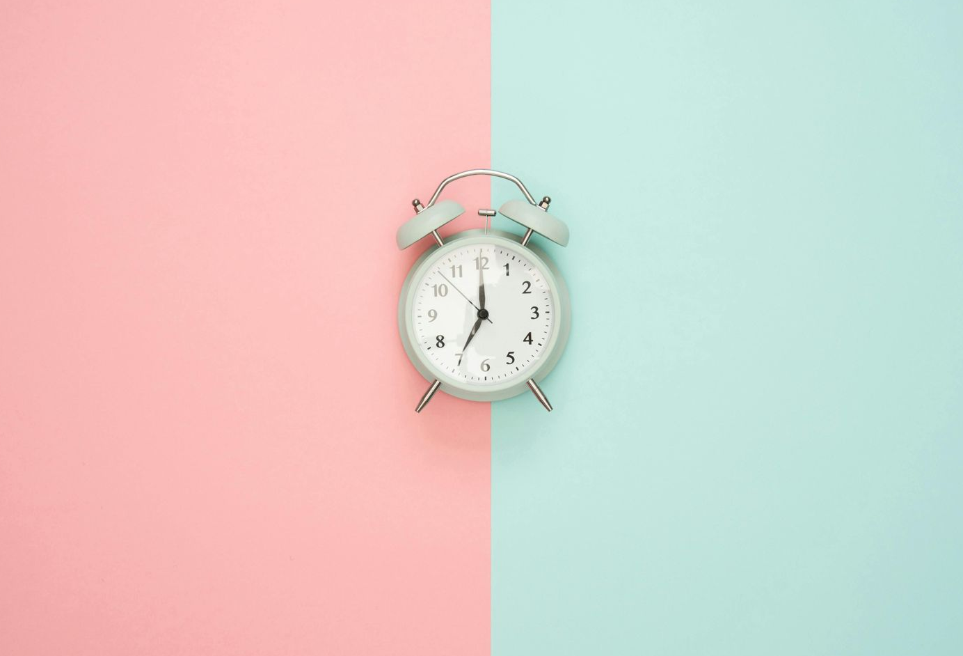 alarm clock on pastel background