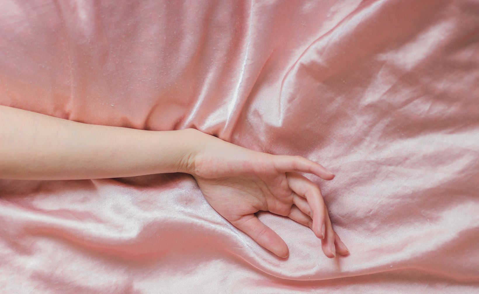 hand resting on satin
