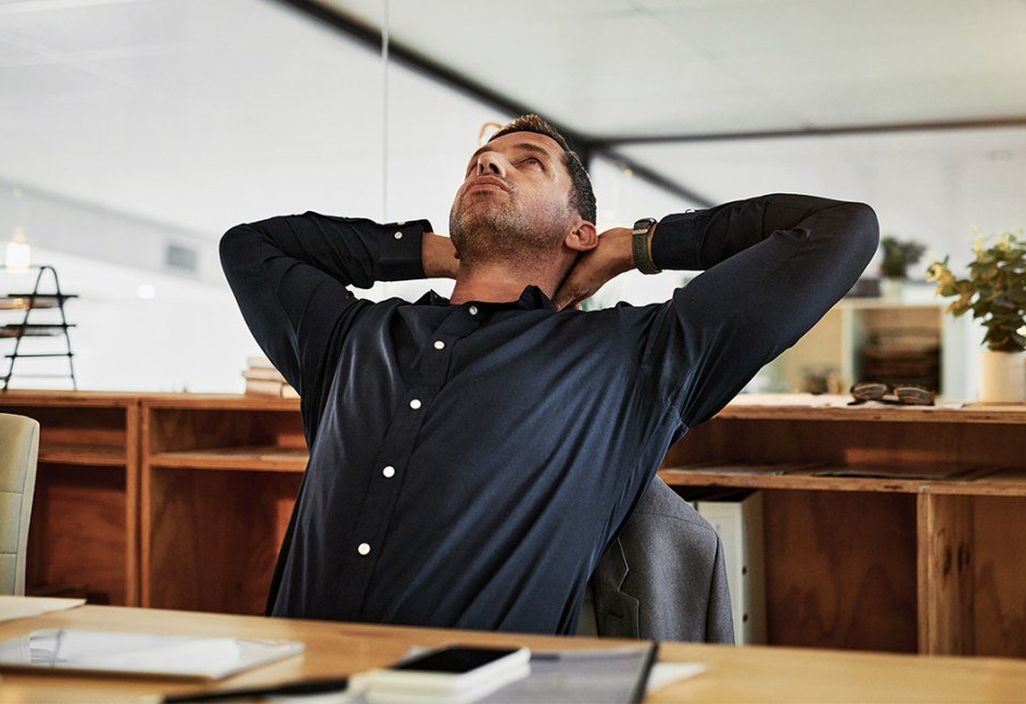 male stretching at his desk