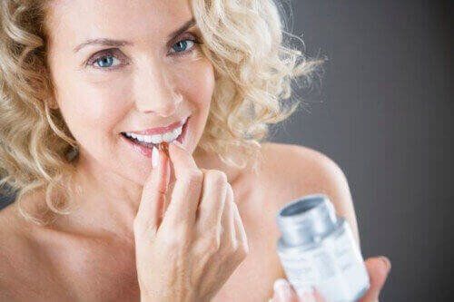 woman taking a vitamin pill