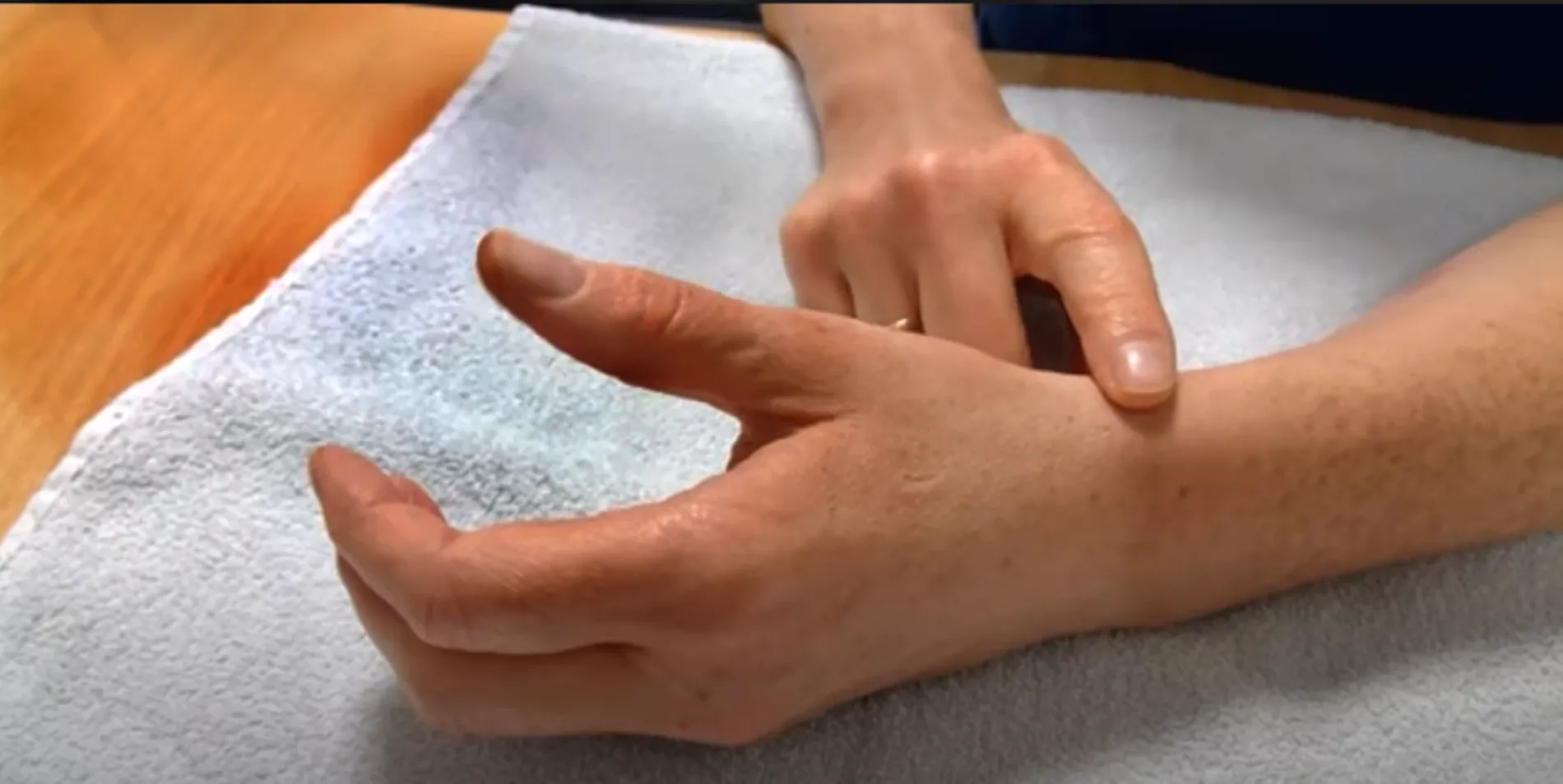 finger touching wrist