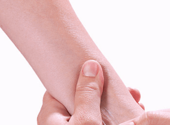 thumb massaging a forearm