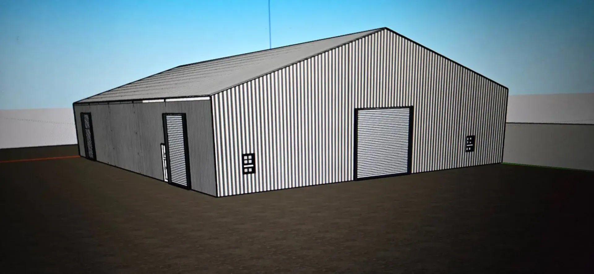 Metal warehouse building with corrugated walls, roll-up doors, and a small entry door on a flat lot