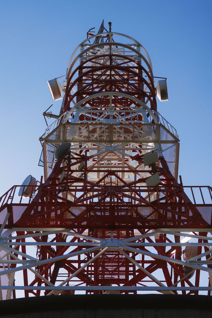 Red metal tower structure against a clear blue sky