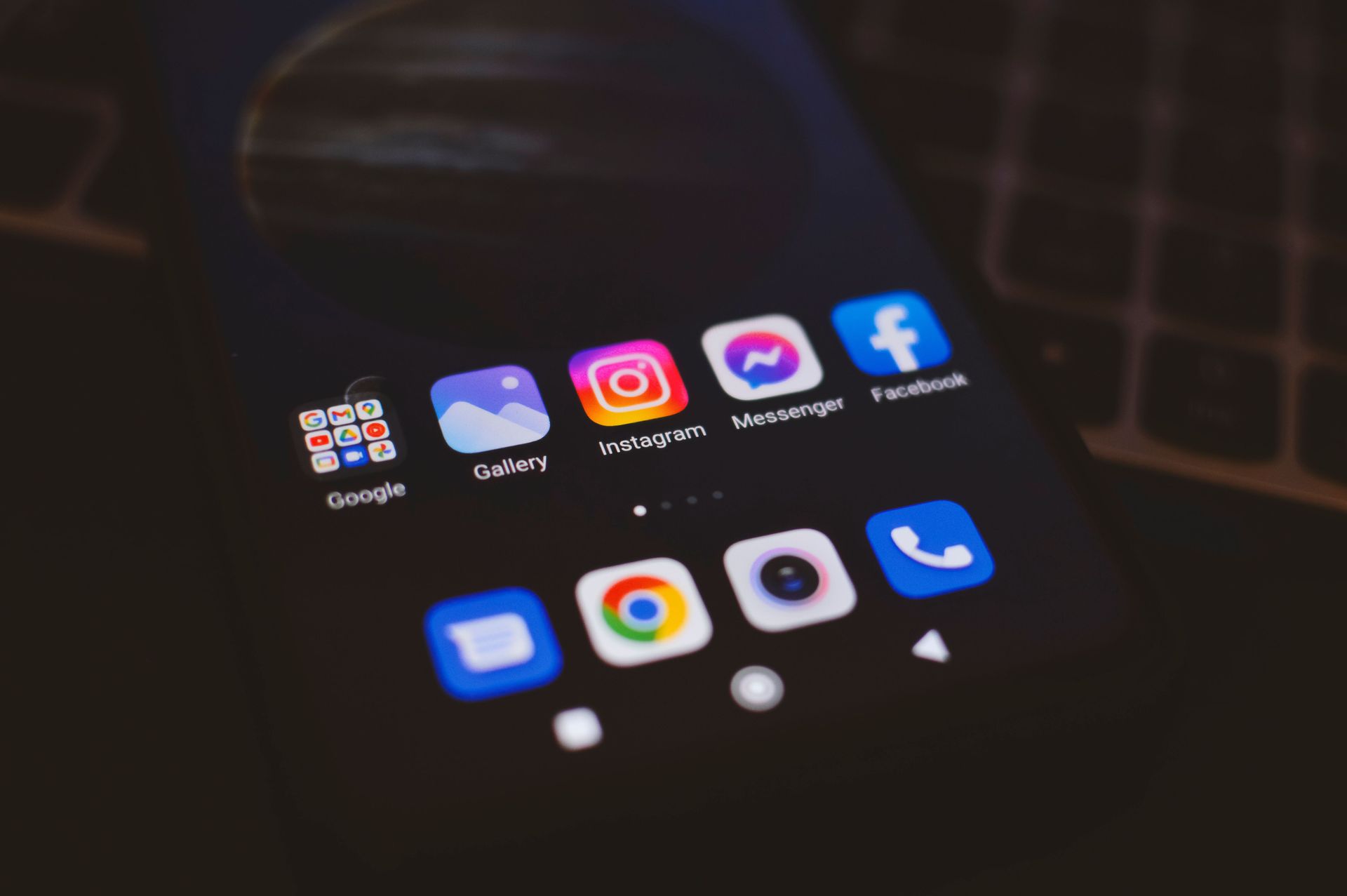 Smartphone home screen with social media app icons on a dark background
