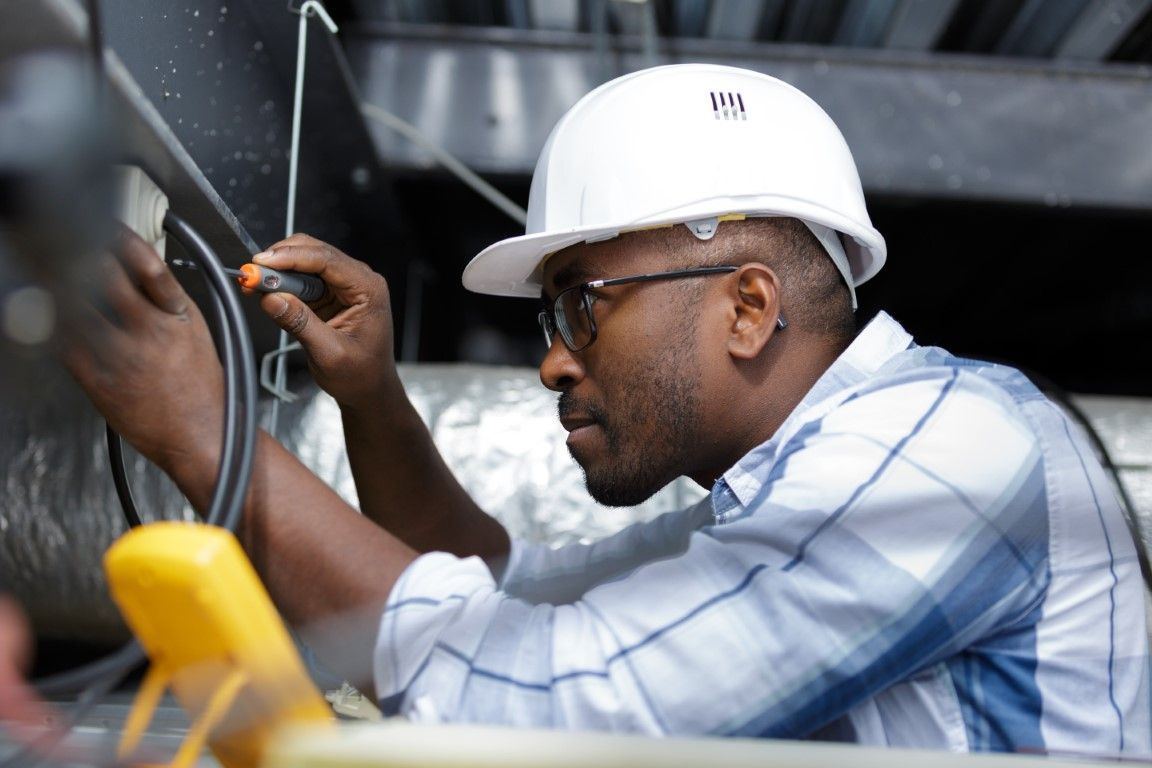 Electrician testing electrical panel