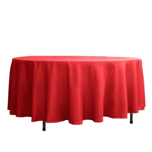 A round table with a red tablecloth on it.