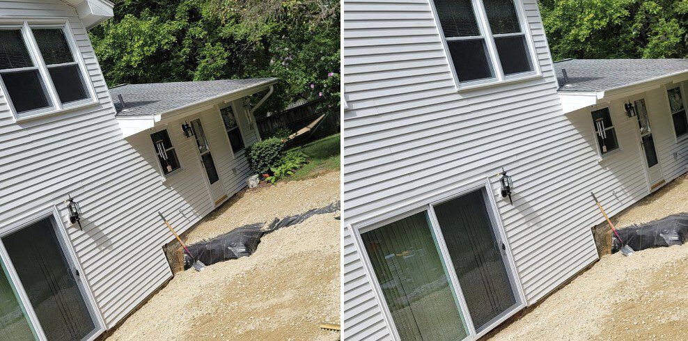 House with damage from what appears to be a flood. Debris visible around foundation, siding damaged.