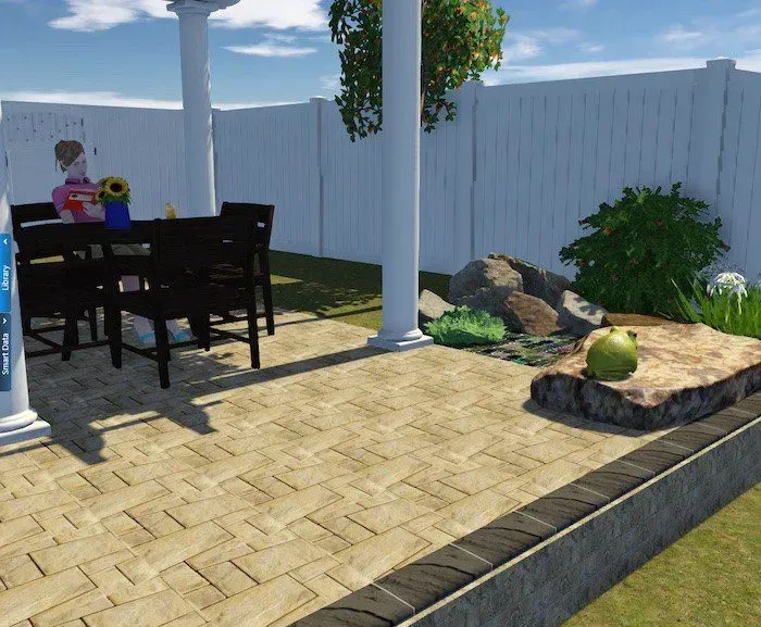 Patio with table, chairs, person, and landscaping in front of a white fence.