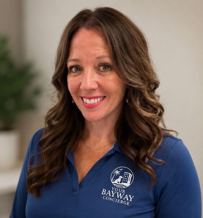 Portrait of a smiling woman in a blue Bayway polo shirt against a blurred indoor background