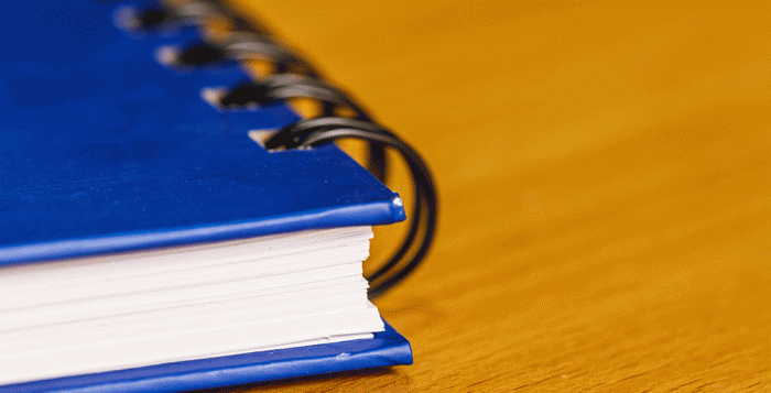 Blue handbook on cedar desk 