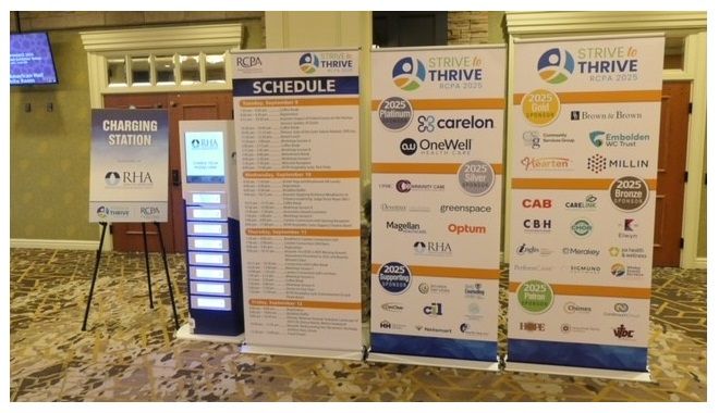 Event signage including a schedule and sponsor banners for the Strive & Thrive 2024 conference.