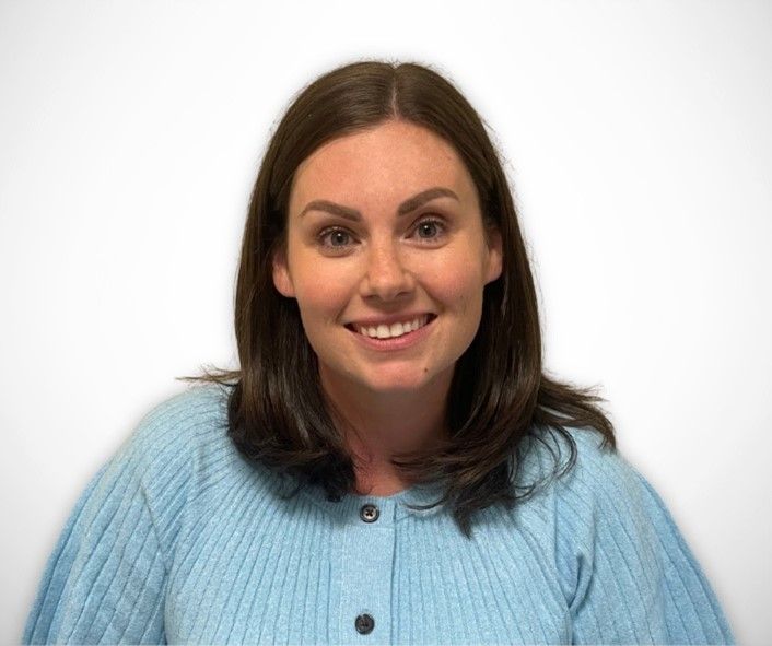 Portrait of Allison Seeley in blue shirt and white background