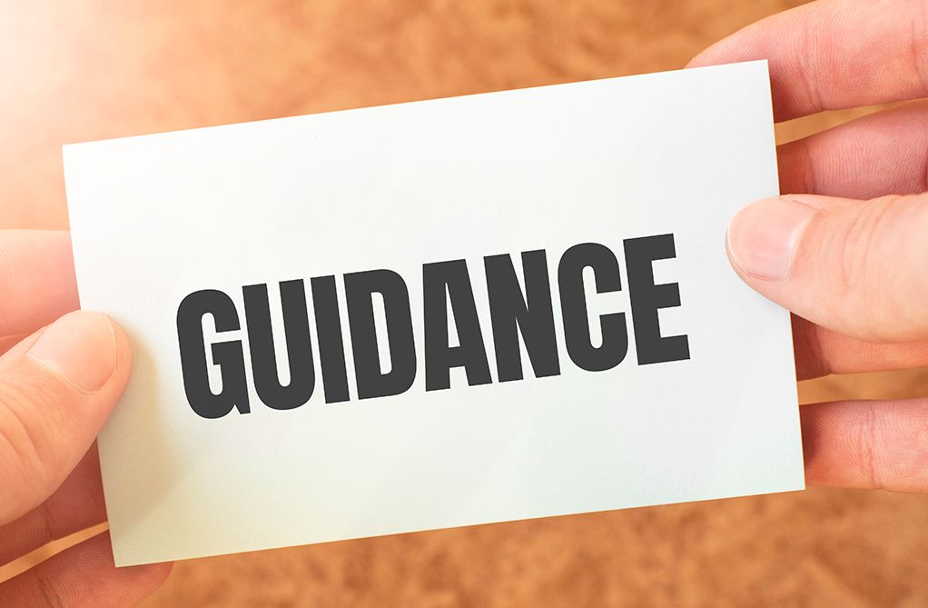 Person holding a slip of paper with the word