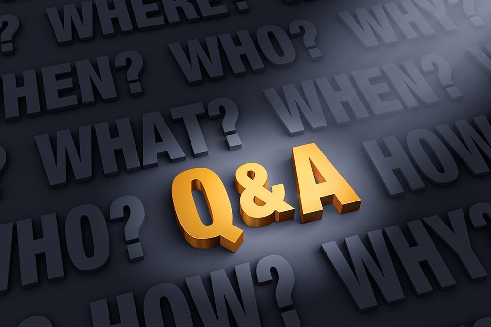 Q&A letters in gold illuminated by light on black background