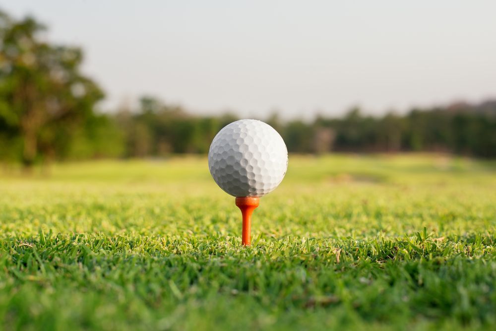 Golf ball on orange tee
