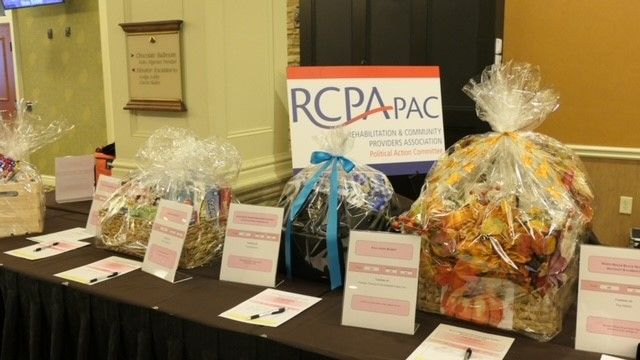 Table with items for silent auction, with RCPA PAC sign behind