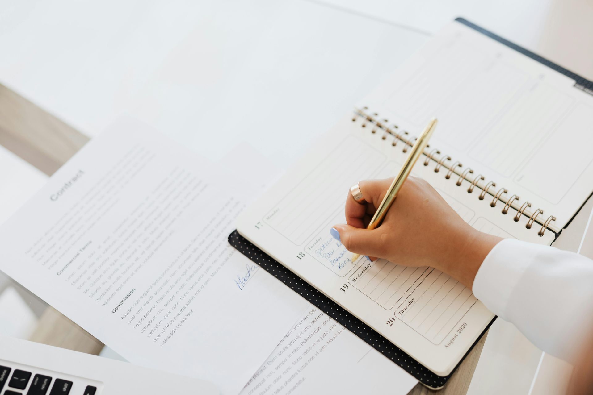 Person writing in planner