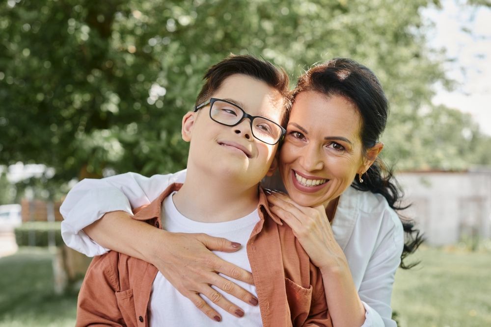 Woman hugging a boy with intellectual disabilities
