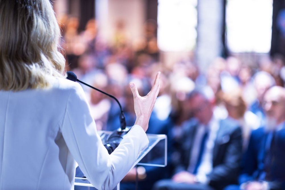 Woman speaking to conference attendees