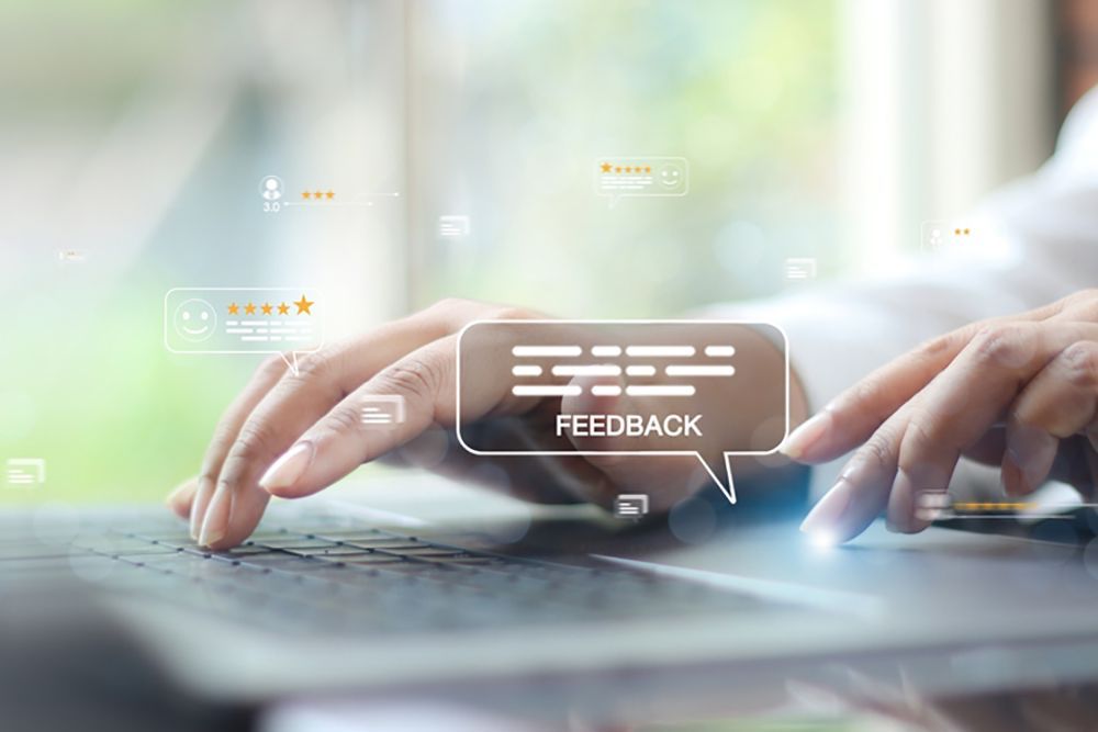 Person typing on keyboard with text box above fingers reading