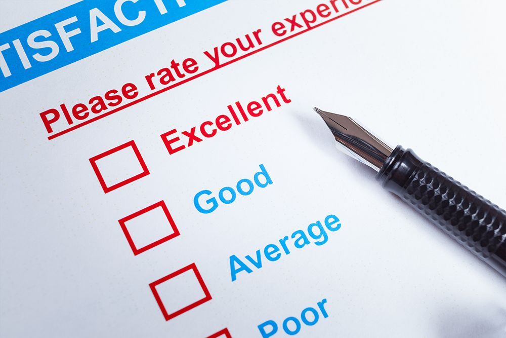Survey showing rates ranging from Excellent to Poor, with pen next to boxes