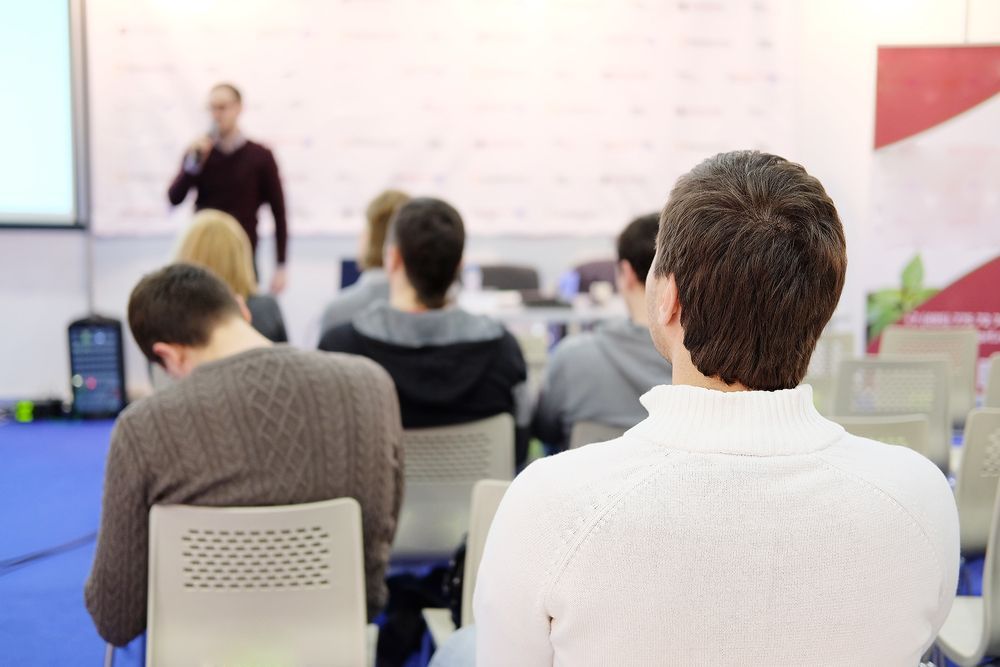 Person listening during seminar to instructor