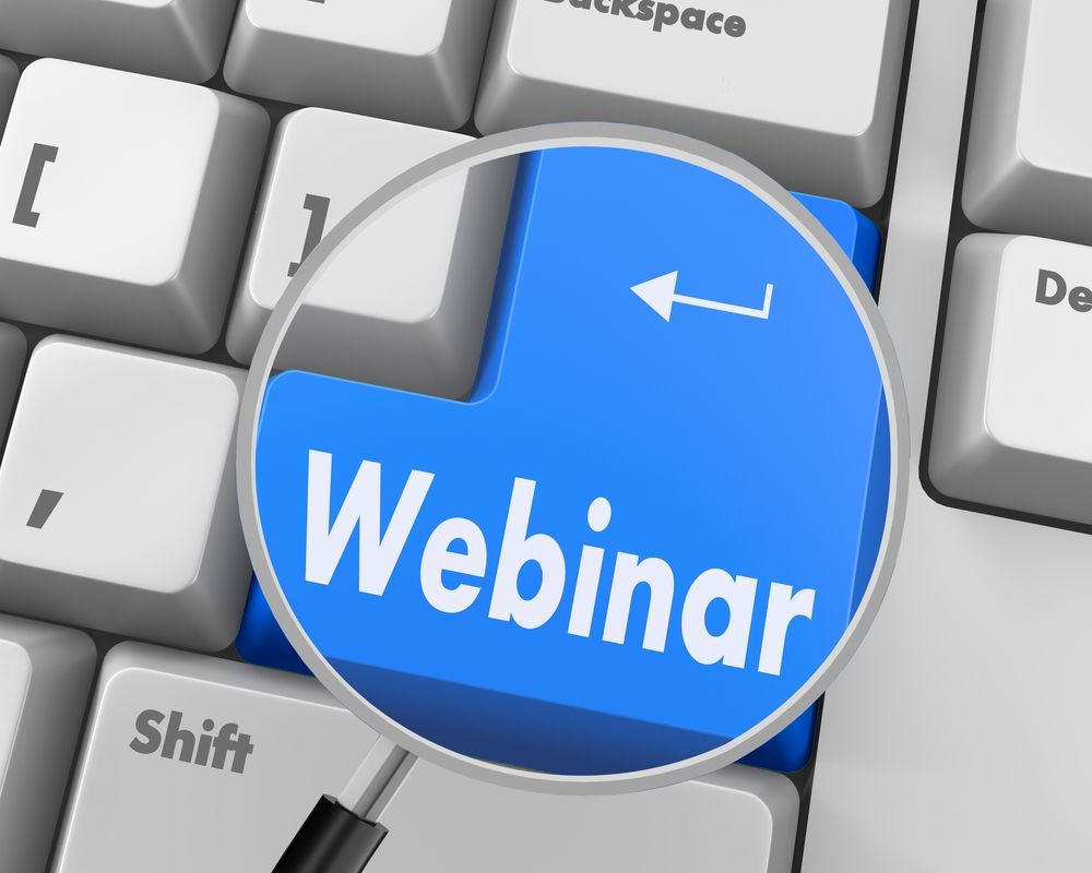 Blue “Webinar” button on a computer keyboard