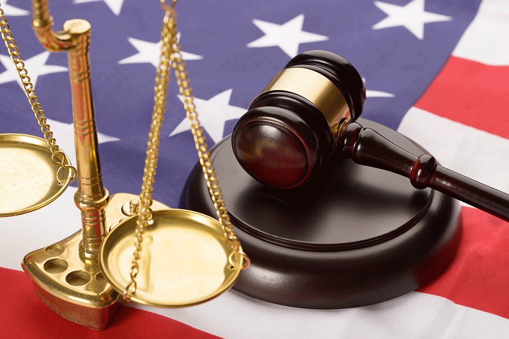 Gavel and judgment weights lying on American flag