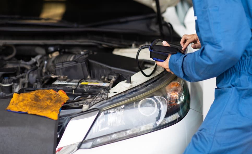 A Mechanic Is Looking Under The Hood Of A Car — North Queensland Diesel Tune In Kirwan, QLD