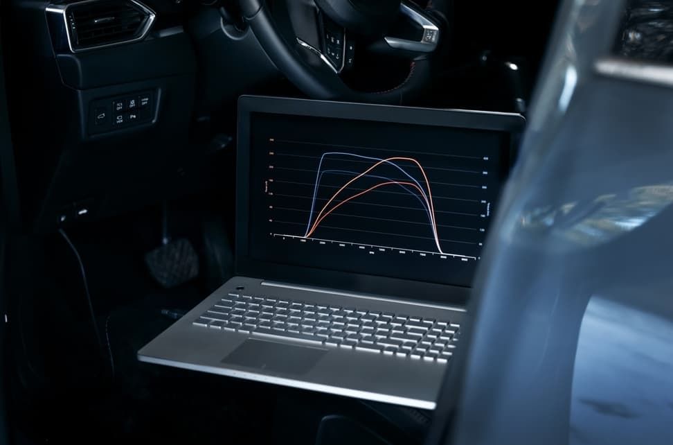 A Man Is Adjusting A Tire On A Car With A Machine — North Queensland Diesel Tune In Kirwan, QLD