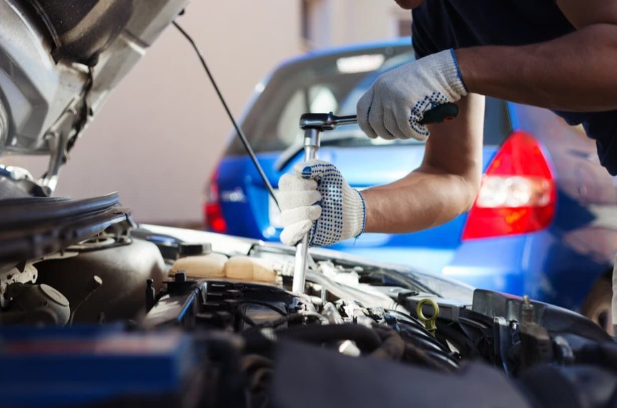 A Man Is Working On The Engine Of A Car With The Hood Open — North Queensland Diesel Tune In Kirwan, QLD