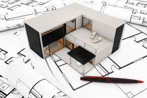 A model house is sitting on top of a blueprint next to a pen built by a Honolulu painting company