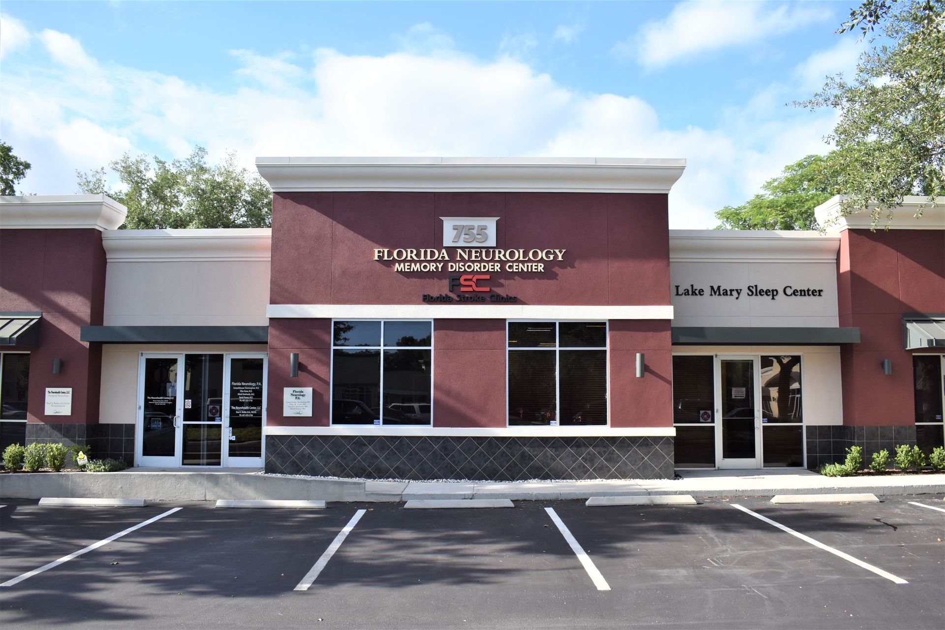 The front of a building with a parking lot in front of it