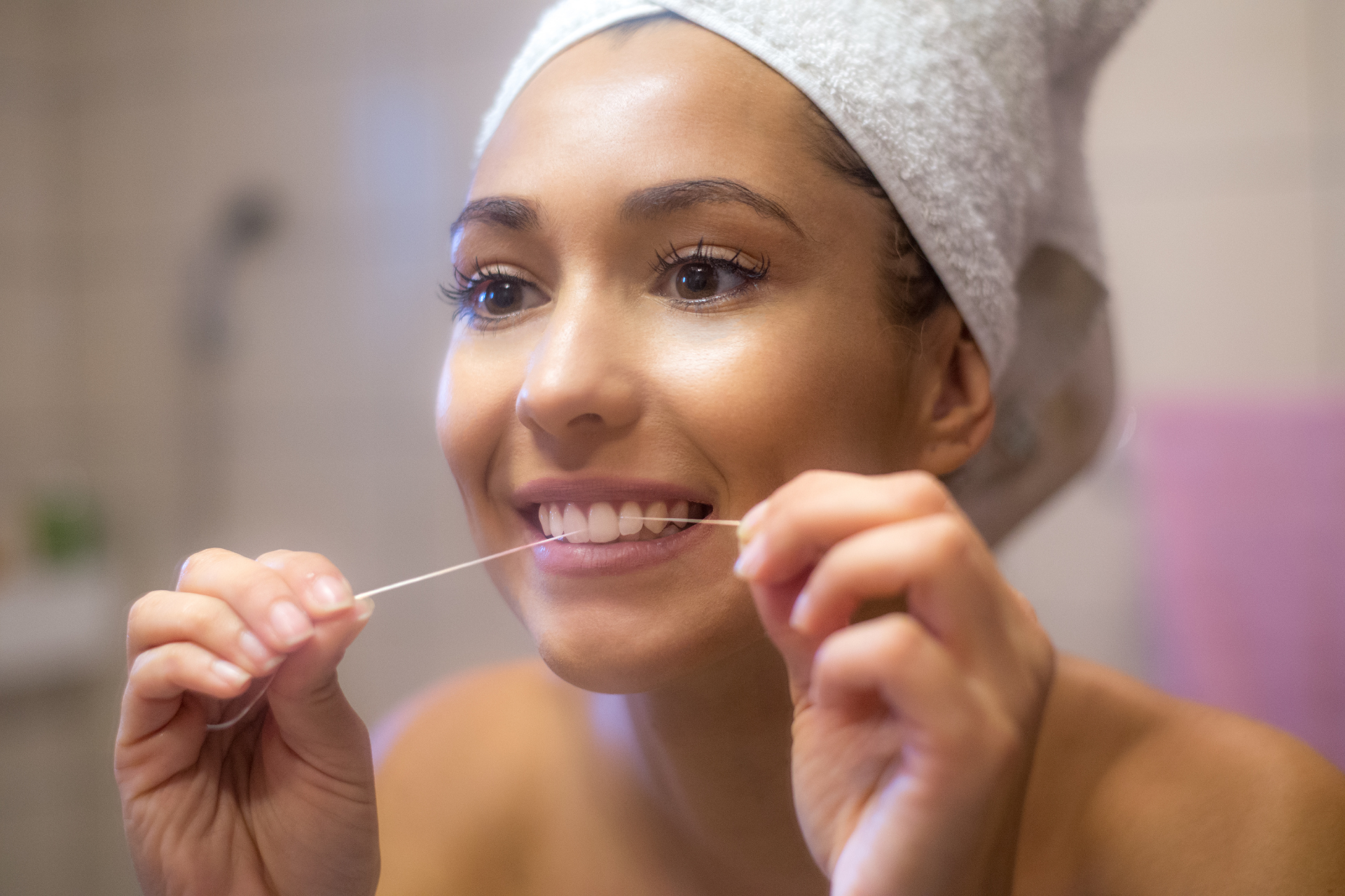 a woman starting her morning with dental floss
