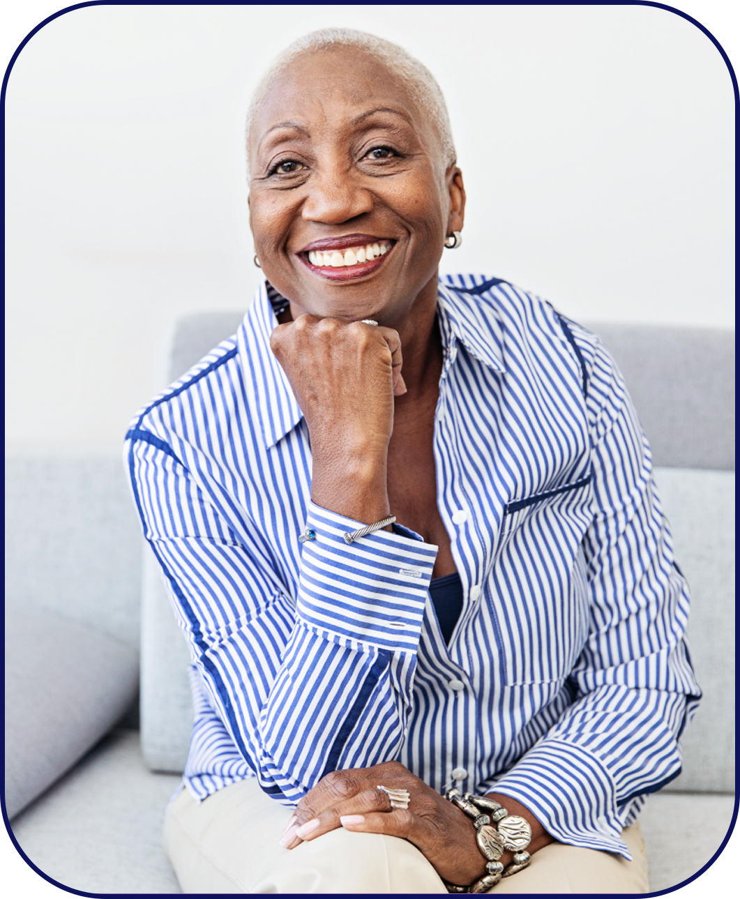 Senior woman sitting on a sofa with a healthy smile