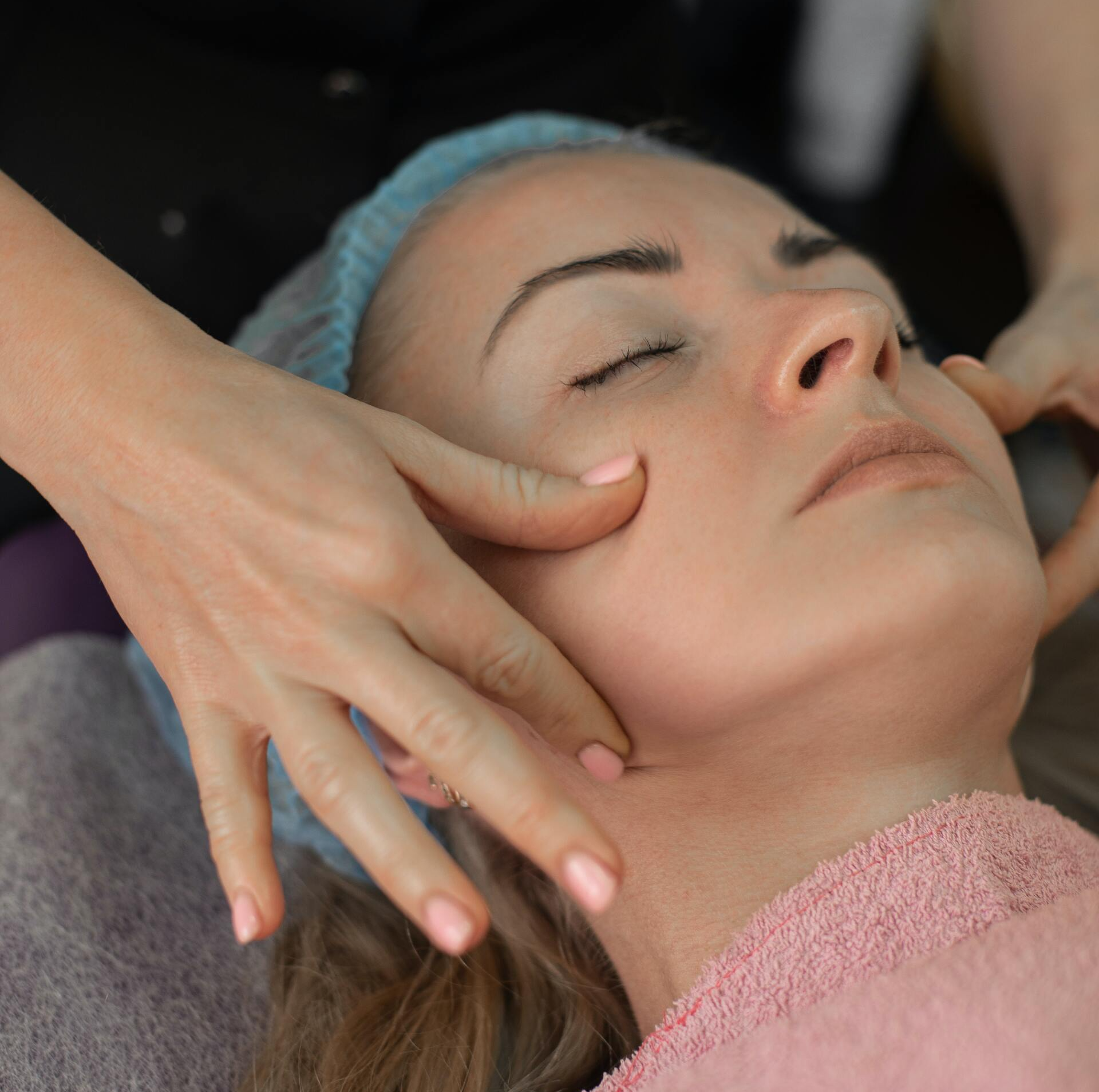 massaging woman's jaw