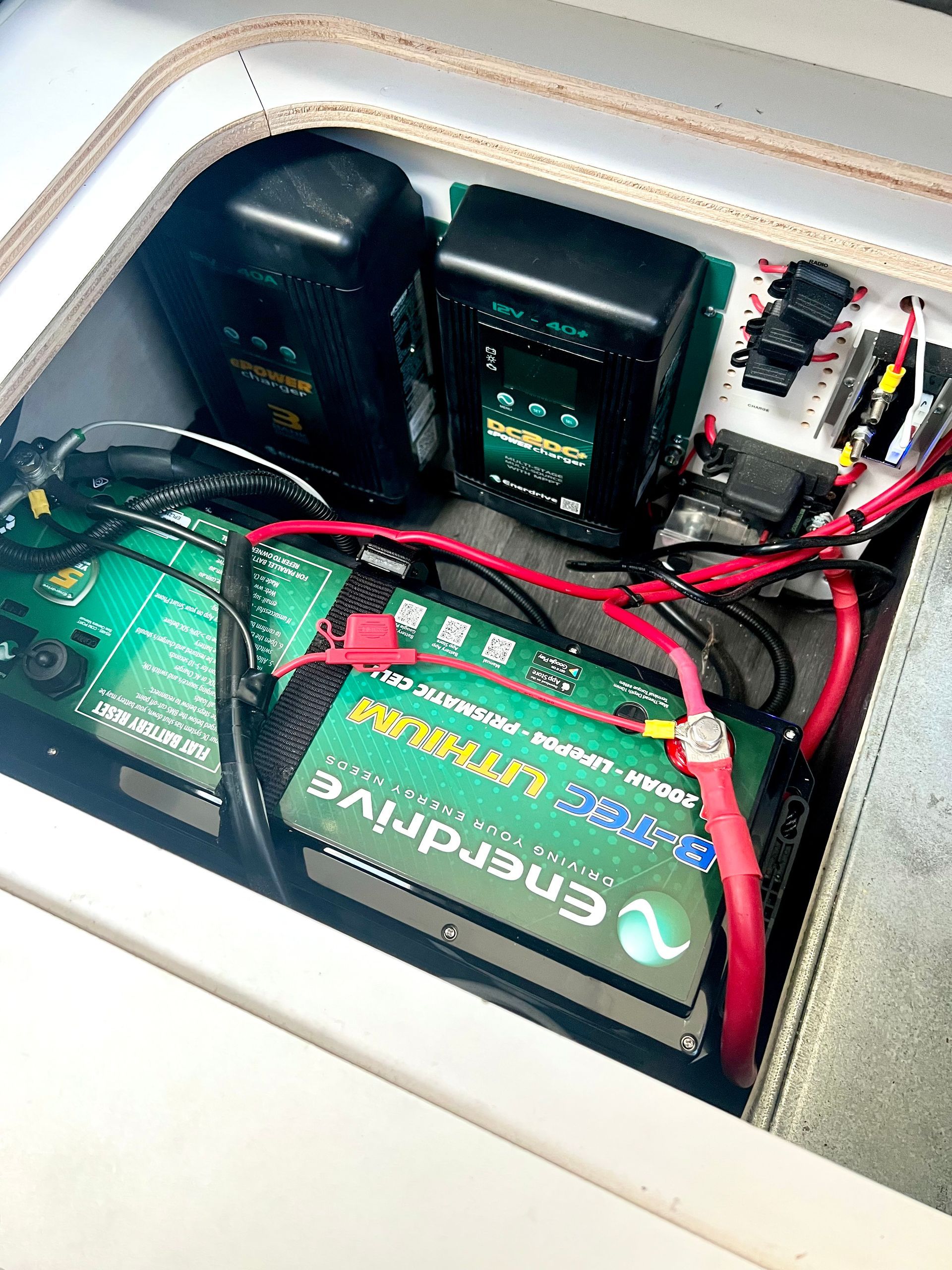A green battery is sitting inside of a boat.