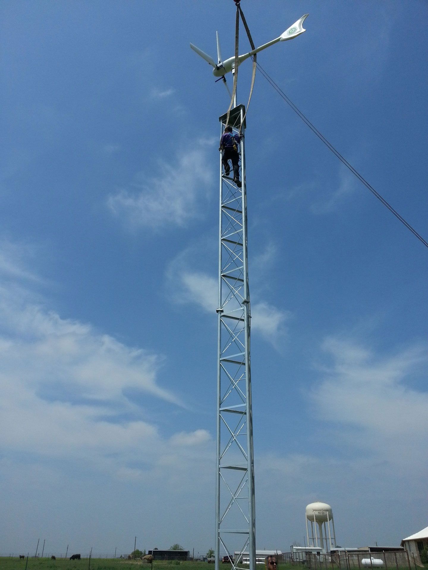 A tower with a wind turbine on top of it