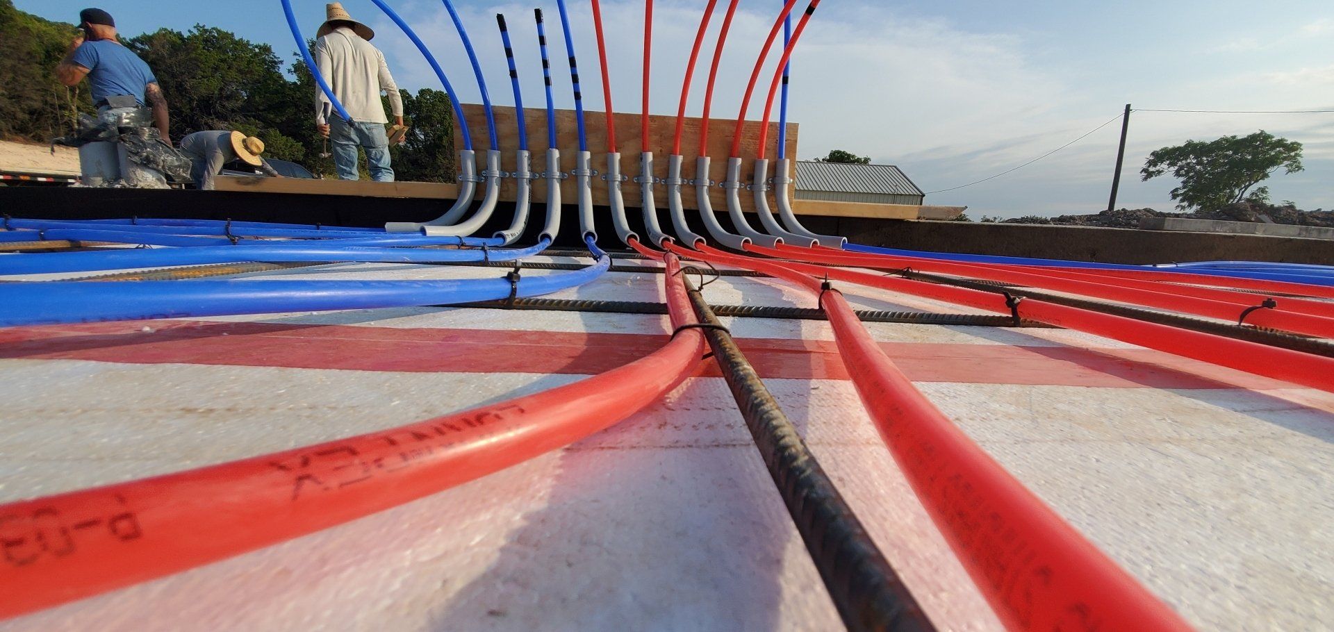 A bunch of electrical wires are laying on the ground.