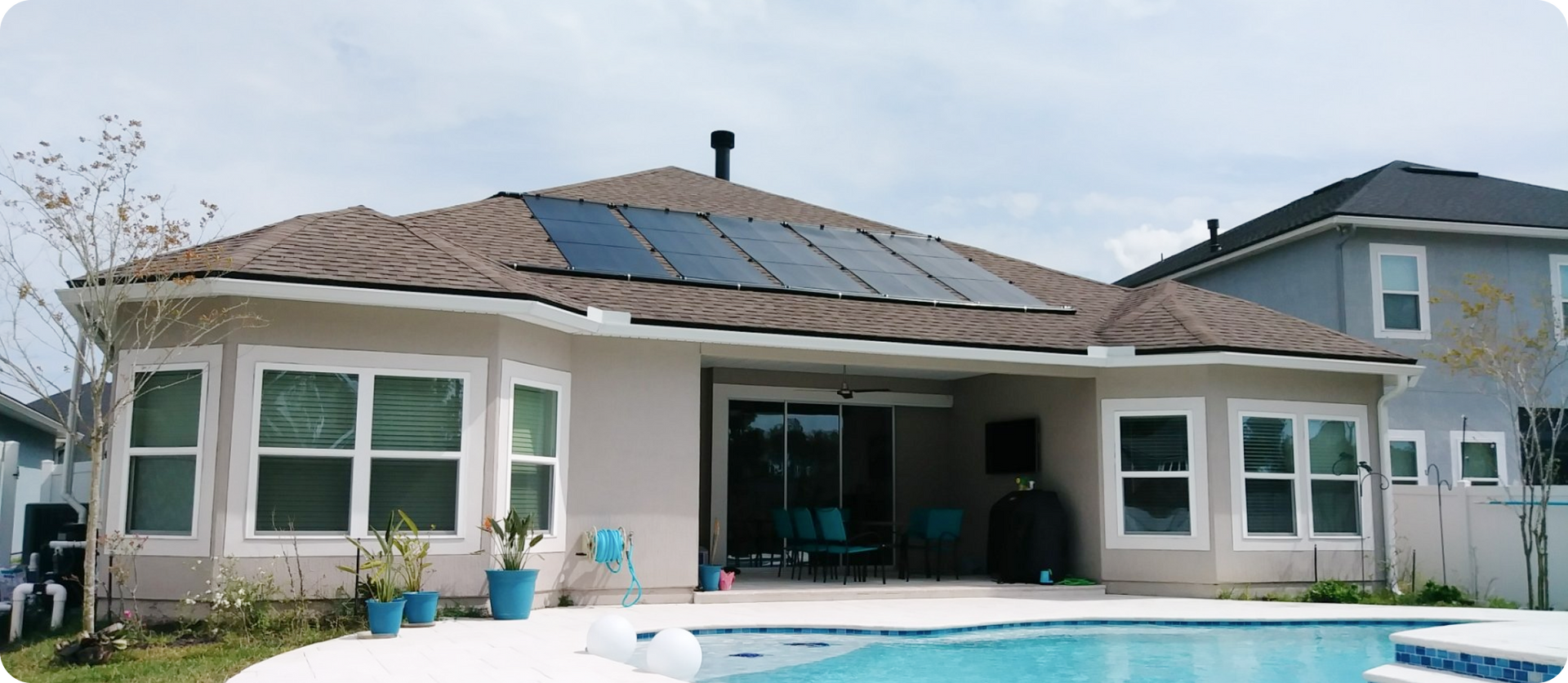A house with a pool and solar panels on the roof