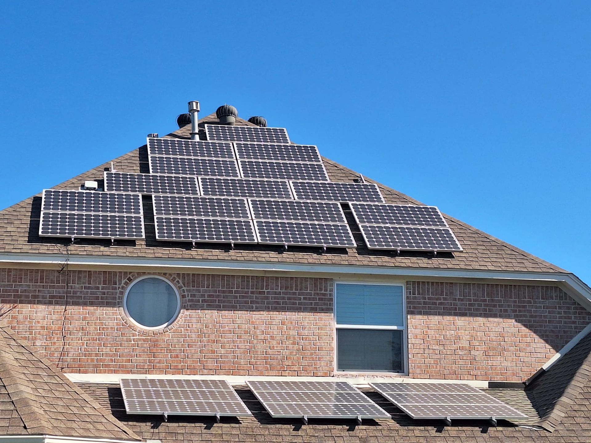 A brick house with solar panels on the roof
