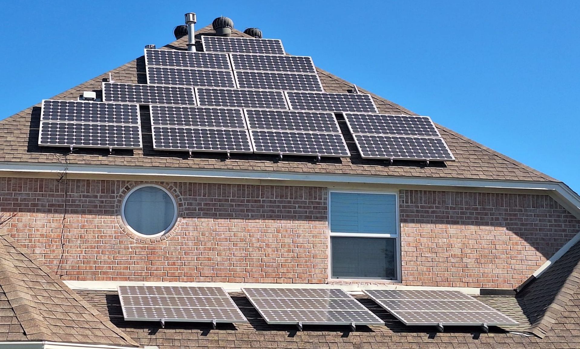 A brick house with solar panels on the roof