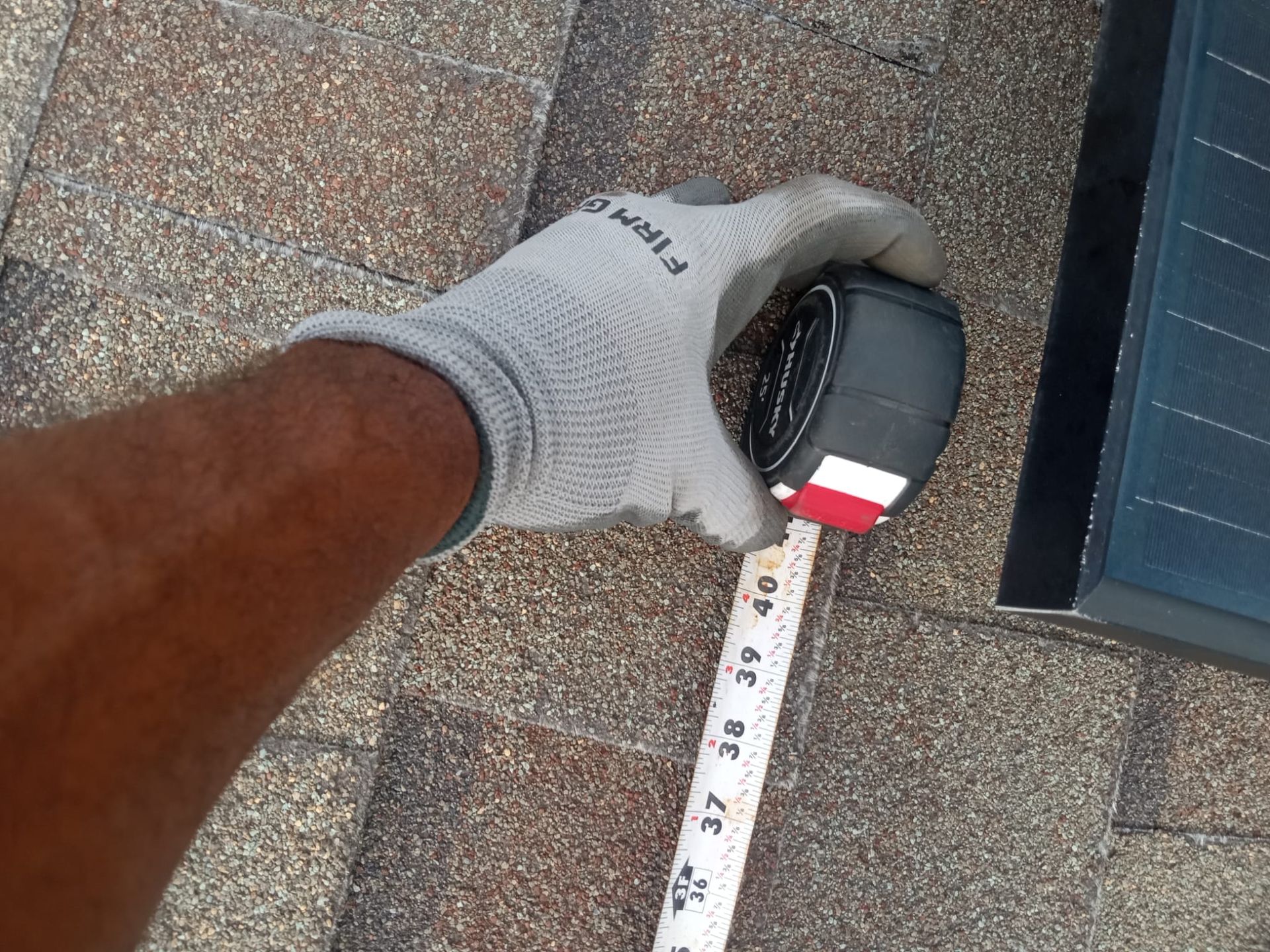A person is measuring something with a tape measure