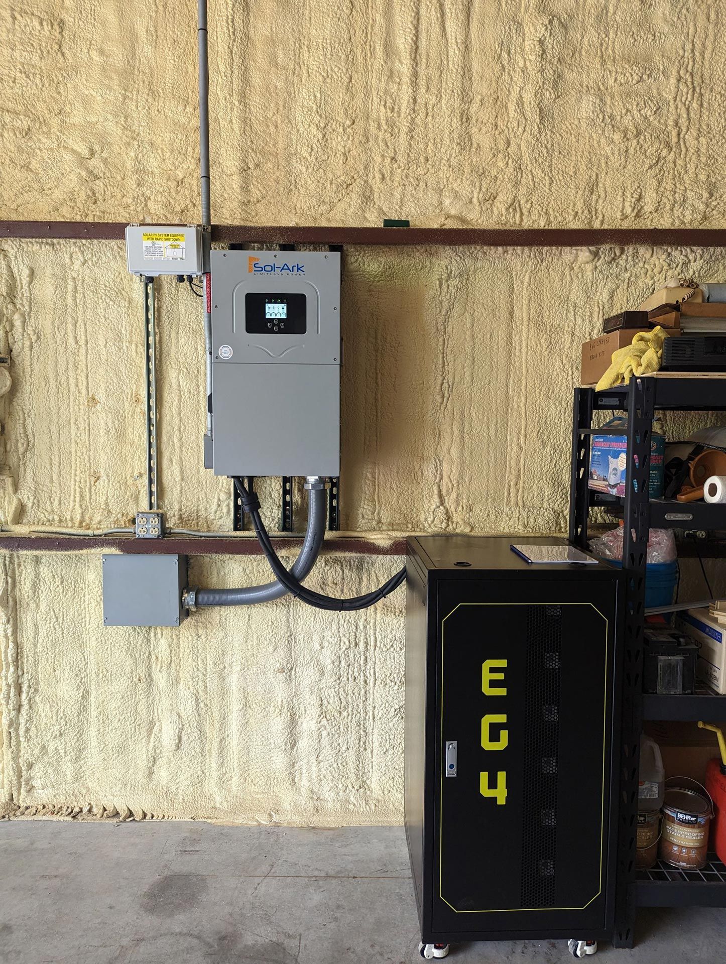 A black box with the word ec4 on it is in a garage next to a wall.