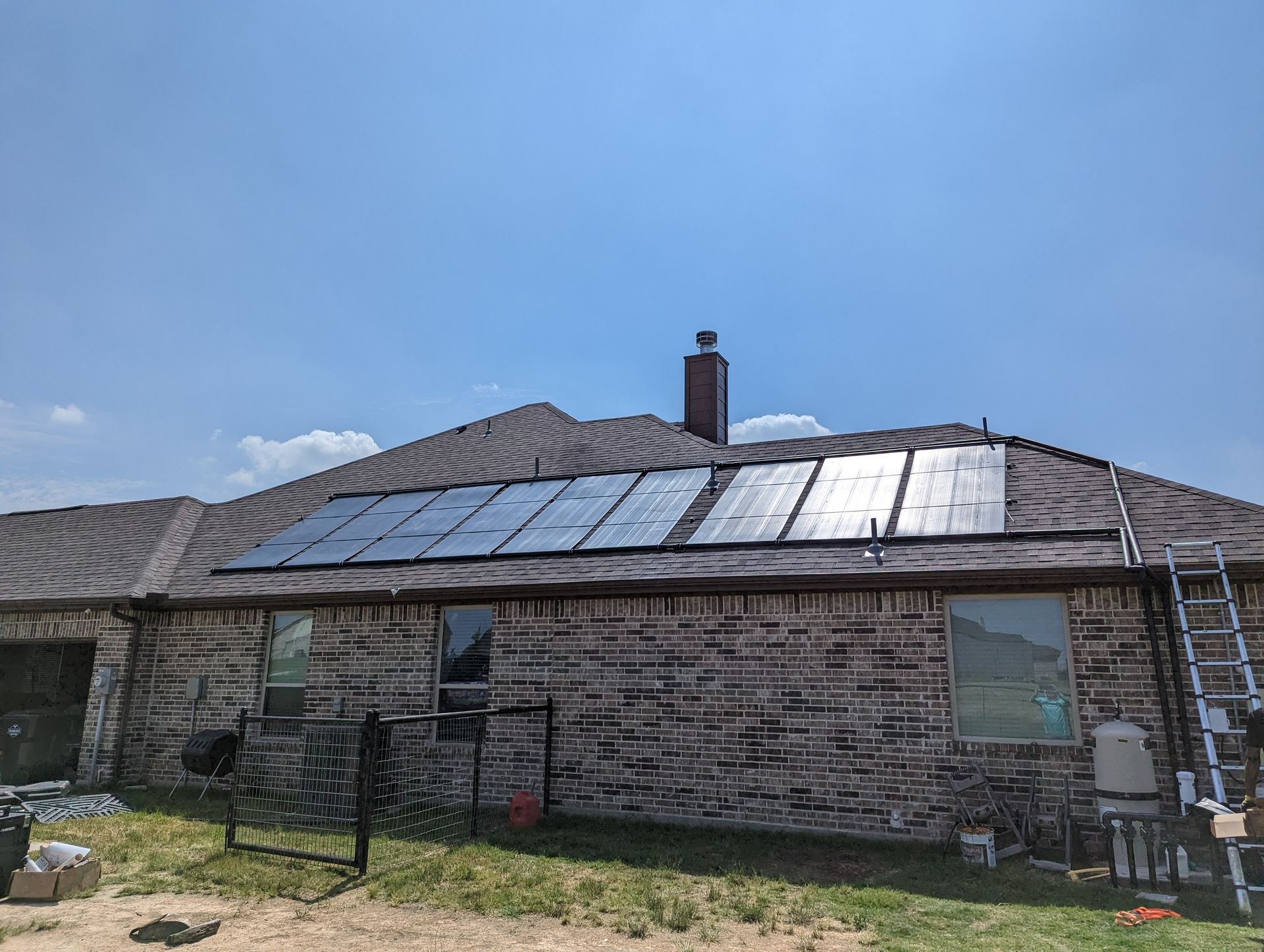 A brick house with solar panels on the roof.