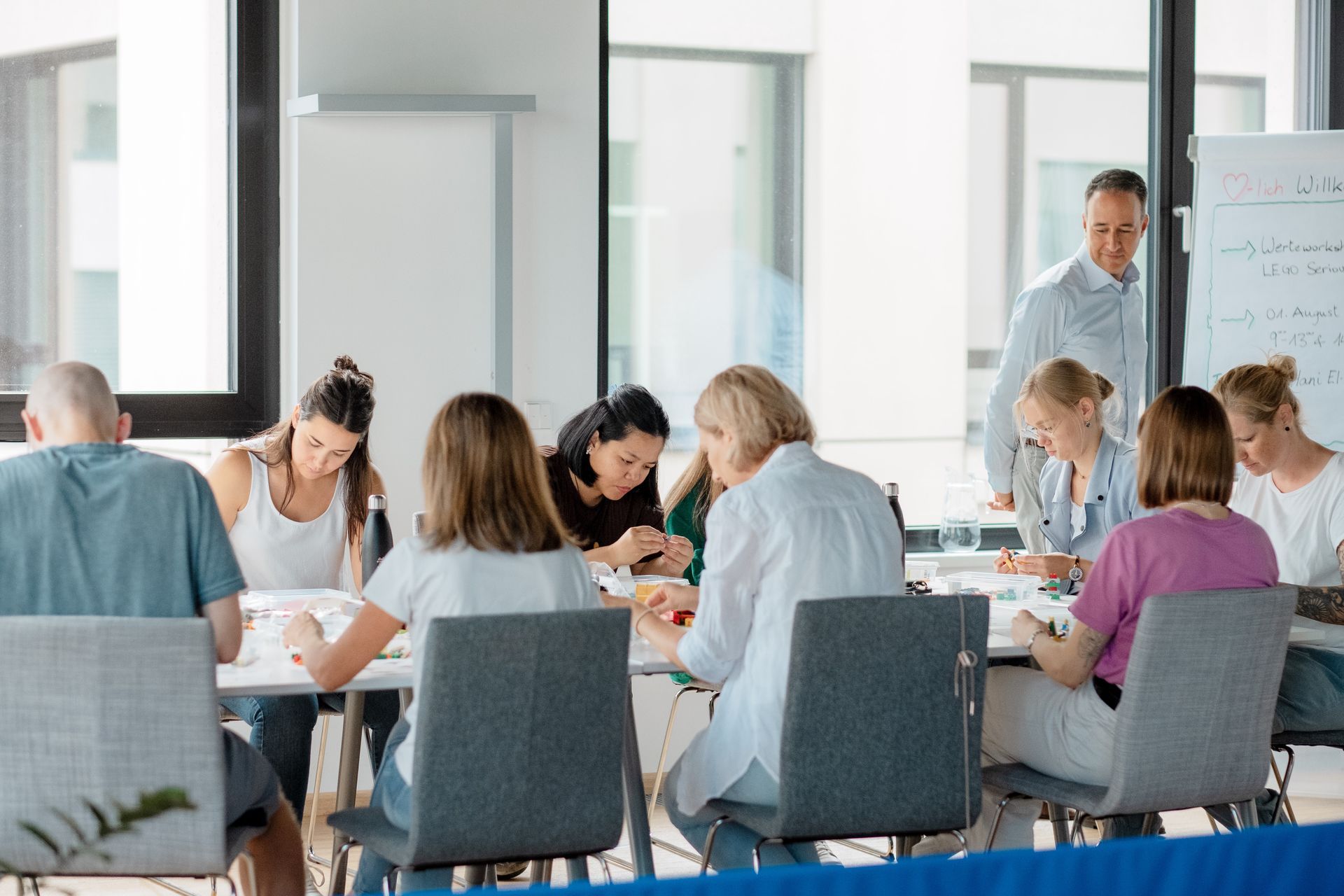 A group of people are sitting around a table in a conference room.