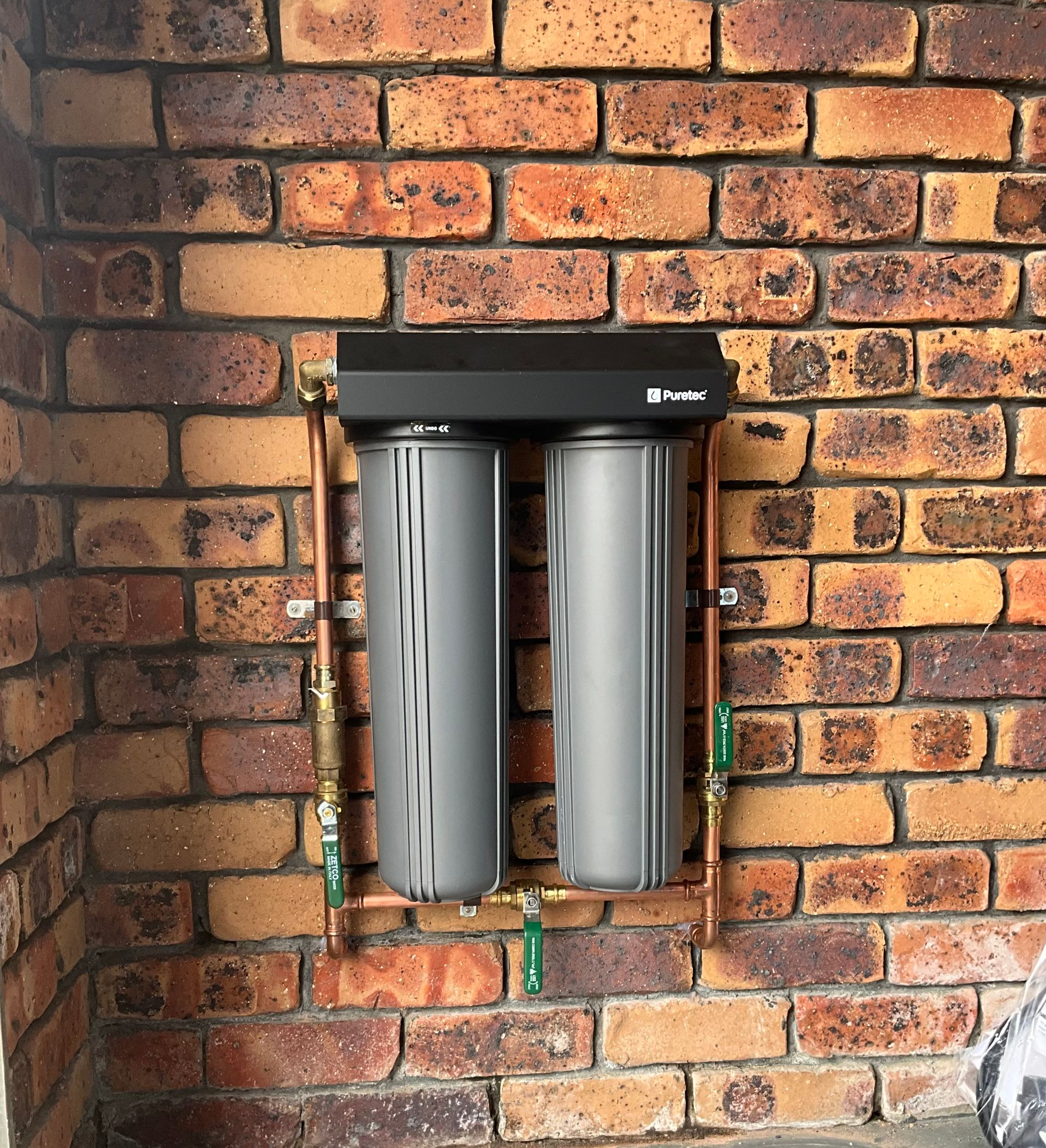 Neat whole-house water filter system mounted on the exterior wall of an Australian home, whole house water filter Warrnambool