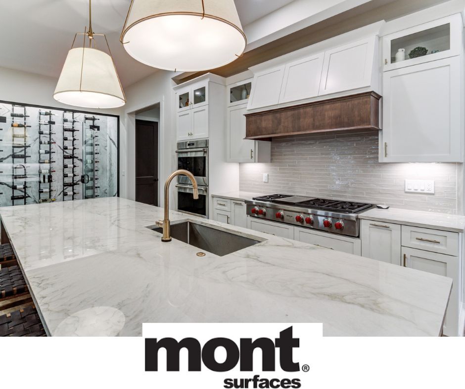 Modern kitchen with white cabinets, marble countertop, and wine storage.